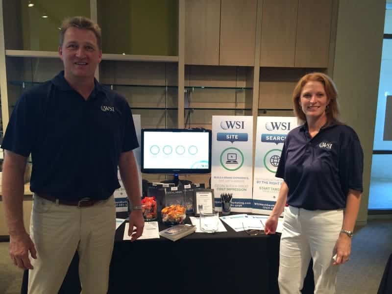 andreas and georgia standing in front of booth