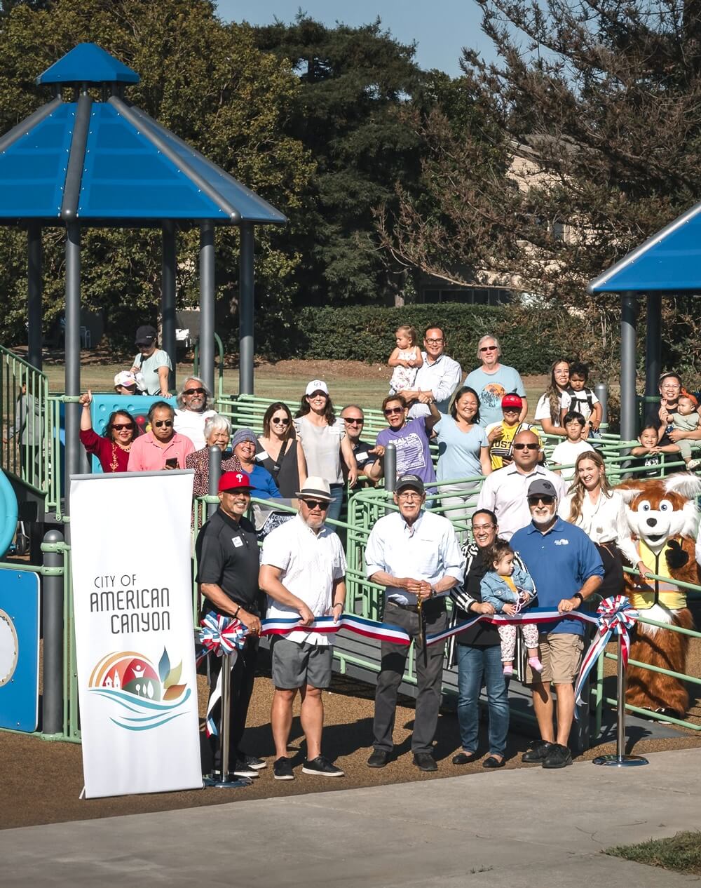 people in group at the park doing a ribbon cutting